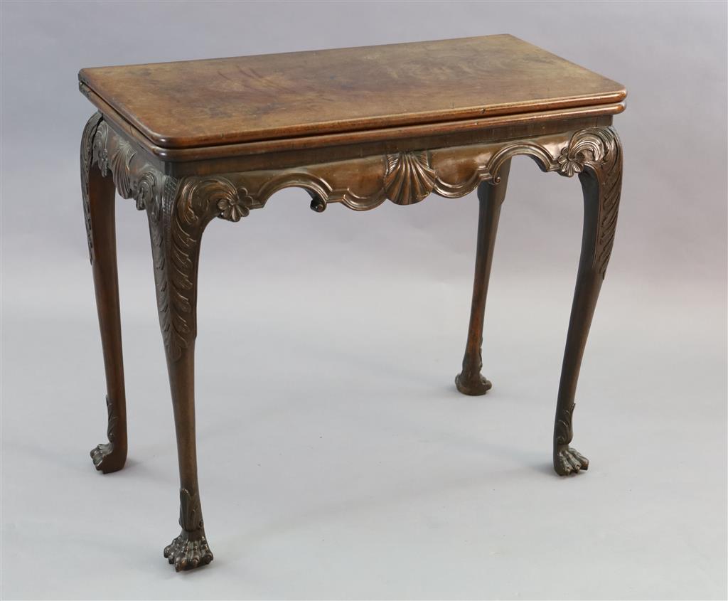 A mid-18th century Irish carved walnut folding top card table, W.2ft 9in. D.1ft 4in. H.2ft 5in.